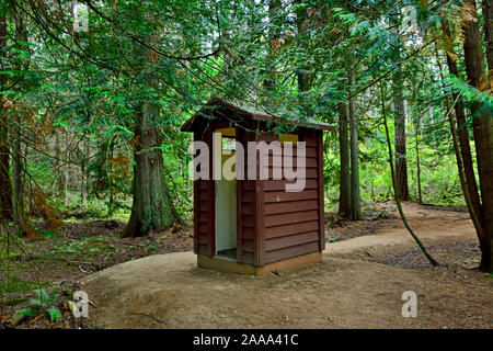 An outdoor outhouse on a hiking trail in the forest on Vancouver Island, British Columbia Canada. Stock Photo