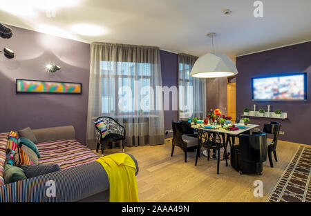 Modern interior of studio apartment. TV and set table. Living room. Stock Photo