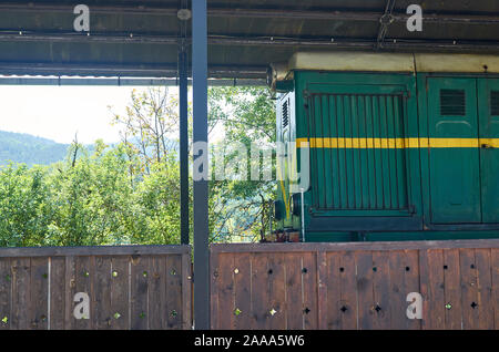 Green locomotive parked in a railway station - detail Stock Photo