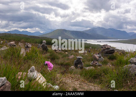 Rose and rock balancing or stone balancing in Loch Loyne, Northwest Highlands of Scotland, UK Stock Photo