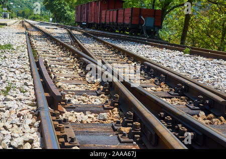 Railway tracks with wagons on one track Stock Photo