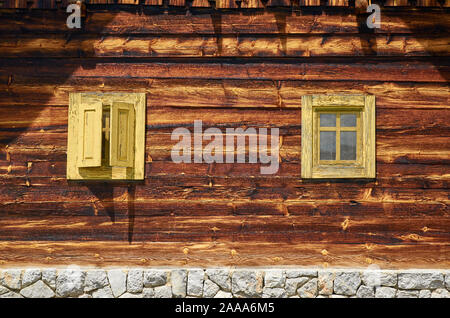 Windows of a wooden cottage in a traditional village style Stock Photo