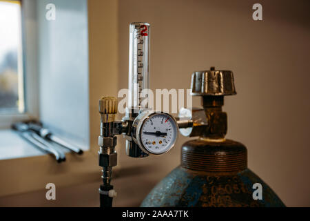 Gas cylinder with pressure gauge connected with pipe. Stock Photo