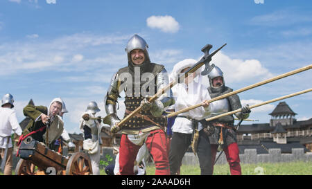 Knights in offensive. Knights defending their fortress, artilleryist shoot from the cannon Stock Photo