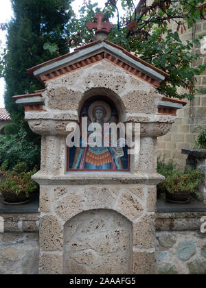 Close up of a stone monument with a painted icon. Photographed at the Holy Monastery of St. Stephen in Meteora, Greece. Stock Photo