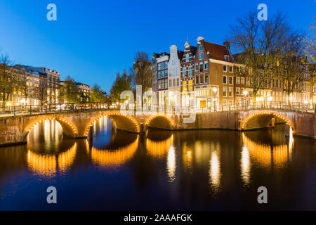 AMSTERDAM, THE NETHERLANDS - October 30, 2019: A bridge with lights over the Keizersgracht Canal during the blue hour, AMSTERDAM, THE NETHERLANDS Stock Photo