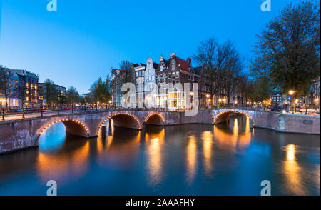 AMSTERDAM, THE NETHERLANDS - October 30, 2019: A bridge with lights over the Keizersgracht Canal during the blue hour, AMSTERDAM, THE NETHERLANDS Stock Photo