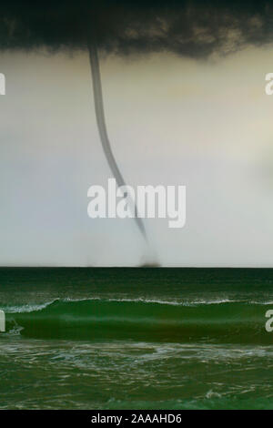 bad weather and storm with the wind on the sea. tornado over the ocean, nature force background - huge tornado, bright lightning in dark stormy sky Stock Photo