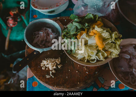 Fresh vegetables and squid rings cooking process in Asian restaurant Stock Photo