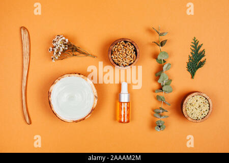 Modern apothecary with natural ingredients. Oil and cream made of herbs. Face roller for self-care. Flat lay style. Stock Photo