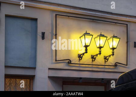 Three vintage classic decorative lights in a row. yellow lights and shadows. Stock Photo