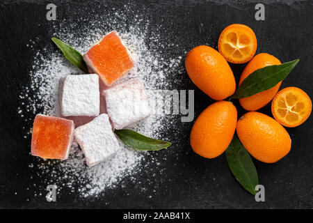 Turkish delights with kumquat flavour on a dark stone Stock Photo
