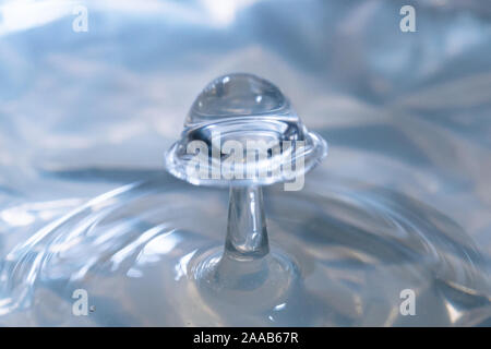 Water drop collision form metallic background Stock Photo