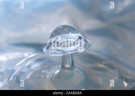 Water drop collision form metallic background Stock Photo