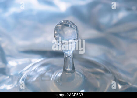 Water drop collision form metallic background Stock Photo