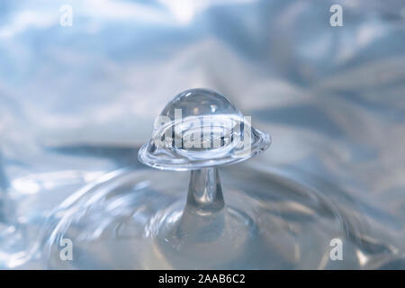 Water drop collision form metallic background Stock Photo