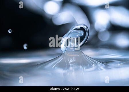 Water drop collision form metallic background Stock Photo