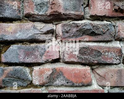 Exterior brick wall made of clinker bricks salvaged from collapsed buildings Stock Photo