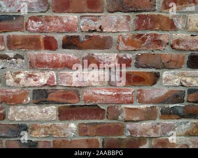 Exterior brick wall made of clinker bricks salvaged from collapsed buildings Stock Photo