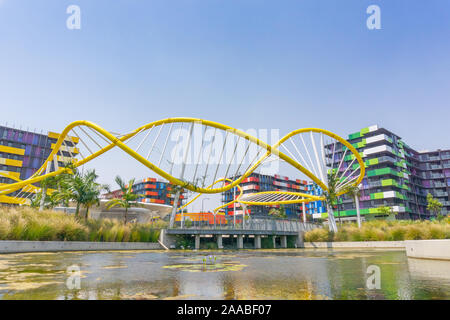 Gold Coast Australia - November 19 2019; Trendy colorful apartment buildings beyond modern bright yellow wave-like sculptural structure Stock Photo