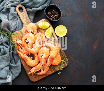 Shrimps served with lemons and spices on a black background Stock Photo