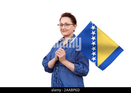 Bosnia and Herzegovina flag. Nice portrait of middle aged lady 40 50 years old holding a large flag isolated on white background. Stock Photo