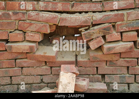 Large hole in the brick wall Stock Photo
