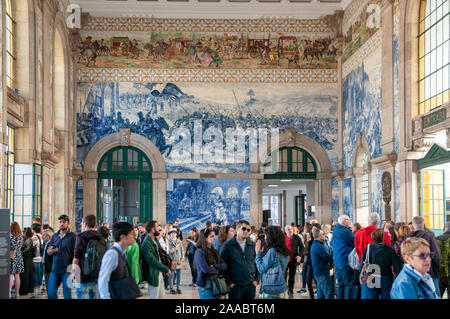 Painted ceramic tileworks (Azulejos) on the interior walls of Main hall of Sao Bento Railway Station in Porto, Portugal Stock Photo