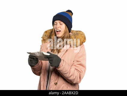 A young woman in winter clothes is holding a handkerchief and has