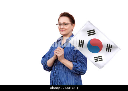 South Korea flag. Woman holding South Korea flag. Nice portrait of middle aged lady 40 50 years old holding a large flag isolated on white background. Stock Photo