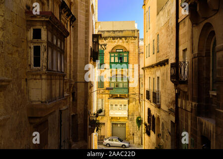 Colorful traditional Maltese balconies in Valletta. Street at sunny day Stock Photo