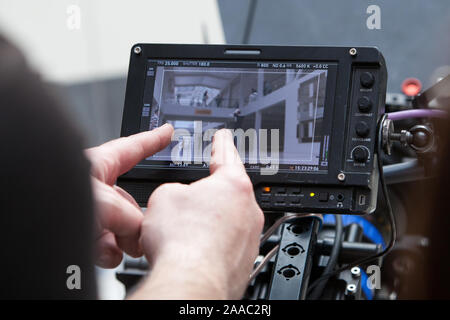 Video cameras on the set, backstage of the movie scene, operator hands Stock Photo