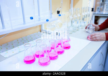 Chemical laboratory with test tubes.Pink liquid in flasks on a research laboratory table Stock Photo