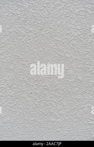 background from texture closeup of decorative plaster on a white wall surface Stock Photo
