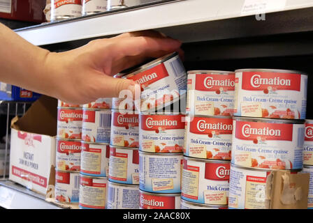 Burnaby, BC, Canada - May 09, 2019 : Motion of people buying Carnation thick cream inside price smart foods store Stock Photo