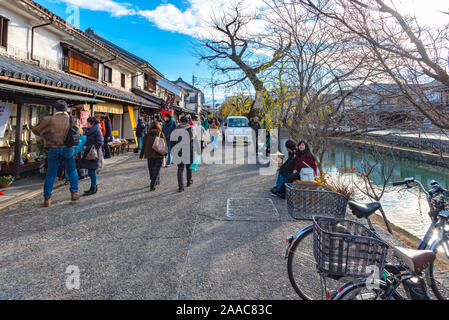View of Kurashiki Bikan Historical Quarter. Townscape known for characteristically Japanese white walls of residences and willow trees lining banks of Stock Photo
