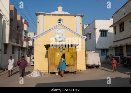 Young Indian woman standing in front of a small shop in Tiruchirappalli,Tamil Nadu, India Stock Photo