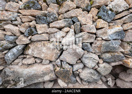 background of large and small hand-stacked natural stones without cement Stock Photo