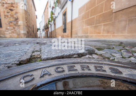 manhole cover in the streets with inscription caceres in the old eponymous historic capital of the province of caceres, extremadura, spain Stock Photo