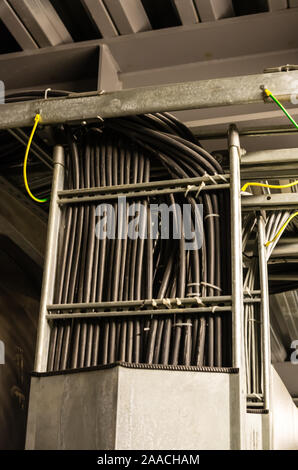 Closeup of black cables in cable tray in industrial building Stock Photo