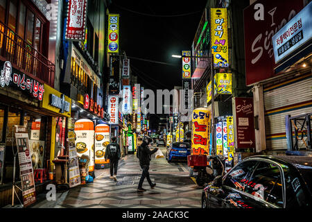 Incheon Korea , 7 October 2019 : Restaurants and bars street view with colourful shop signs and people at night in Incheon South Korea Stock Photo