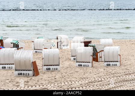 Hooded beach chairs in Baltic sea beach a cloudy day of Summer. Sellin, Rugen Island. Germany Stock Photo