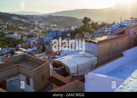 A view from a terrace of Chefchauen, the blue pearl in the mountains of Morocco in Autumn at sunset. A typical touristic destination in Maghreb. Stock Photo