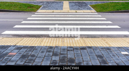 An adapted environment for visually impaired people in a modern city. A special pavement coating is tactile tiles for the disabled. Stock Photo