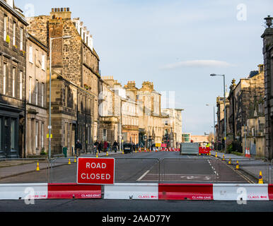 Leith, Edinburgh, Scotland, United Kingdom. 21st Nov, 2019. Trams to Newhaven work starts: Constitution Street is closed to traffic for the next 2-3 years to build the extension for Edinburgh's tram line from to Newhaven, with 8 more stops over 2.91 miles. Trams will start running in 2023, costing £207.3m Barriers are being put up along the road. The work is being undertaken by SFN (Sacyr Farrans Neopul) and MUS (Morrison Utility Services). A road closed sign and barrier Stock Photo
