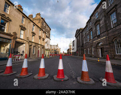 Leith, Edinburgh, Scotland, United Kingdom. 21st Nov, 2019. Trams to Newhaven work starts: Constitution Street is closed to traffic for the next 2-3 years to build the extension for Edinburgh's tram line from to Newhaven, with 8 more stops over 2.91 miles. Trams will start running in 2023, costing £207.3m Barriers are being put up along the road. The work is being undertaken by SFN (Sacyr Farrans Neopul) and MUS (Morrison Utility Services). A closed road barrier of traffic cones Stock Photo