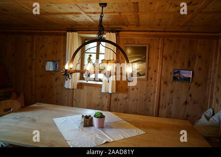 Warm welcoming cozy wooden tyrol hutte inside in the tyrol alm . Stock Photo