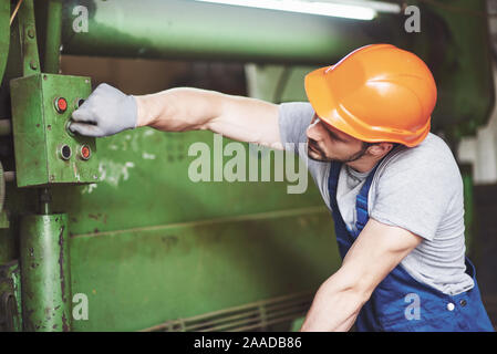 Industrial worker working with lathe in the metalworking industry Stock Photo