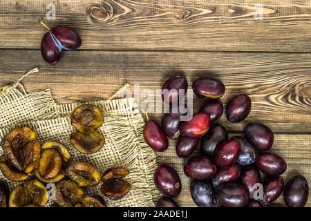 Fresh prune plums on wood background. Stock Photo