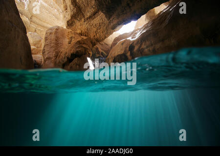 Split level view of water in cave in Wadi Al Shab, Al Sharqiyah South Governorate, Sultanate of Oman. February. Photographed for The Freshwater Project Stock Photo